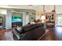 Inviting living room with a large TV, hardwood floors, and plenty of seating at 10597 Alvarado Ct, Seminole, FL 33772