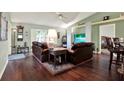 Comfortable living room featuring hardwood floors, lots of clocks, and a ceiling fan at 10597 Alvarado Ct, Seminole, FL 33772