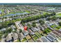 Aerial view of a residential community with lush greenery, a lake, and easy access to the highway at 11438 Ivy Flower Loop, Riverview, FL 33578