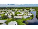 Aerial view of a well-maintained community with lush landscaping, water features, and golf course at 123 Glendower Cir # 123, Sun City Center, FL 33573
