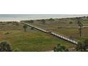 Aerial view of beach access by boardwalk to enjoy the ocean and coastline at 1230 Gulf Blvd # 601, Clearwater Beach, FL 33767