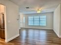 Bright and airy living area featuring new flooring, a ceiling fan, and large windows for ample natural light at 14230 86Th Ter, Seminole, FL 33776