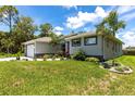 A lovely home with a well-kept lawn and lush landscaping around the foundation at 14422 Chamberlain Blvd, Port Charlotte, FL 33953