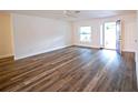 Bright living room featuring wood floors, a ceiling fan, and an open front door at 1536 Palmetto St, Clearwater, FL 33755