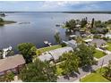 Breathtaking aerial view of a waterfront home with a private dock and access to a tranquil lake at 17 Freshwater Dr, Palm Harbor, FL 34684
