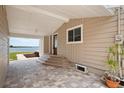 Inviting covered patio with beautiful brick pavers and views of the lake at 17 Freshwater Dr, Palm Harbor, FL 34684