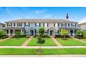 Townhome exterior with well-maintained lawn and coordinated exterior color scheme at 17378 Cruiser Bnd, Land O Lakes, FL 34638