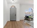 Bright living room featuring hardwood floors, ample natural light, and minimalist decor at 1800 Loch Haven Ct, Trinity, FL 34655