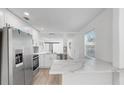 Modern kitchen featuring stainless steel appliances, bright white cabinets, and marble countertops at 1924 48Th S St, St Petersburg, FL 33711