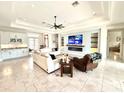 Inviting living room with tile floors, a built-in bar, cozy seating, and an entertainment center for relaxing evenings at 31889 Tortuga Shore Loop, Wesley Chapel, FL 33545