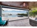 Enclosed patio featuring comfortable seating and scenic views of the pool, private dock, and ocean at 3319 Bayshore Ne Blvd, St Petersburg, FL 33703