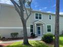 Inviting home entrance with well maintained lawn and garden at 3665 Country Pointe Pl, Palm Harbor, FL 34684