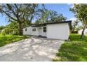 Charming single-story home with a well-maintained lawn and inviting curb appeal at 4220 E Regnas Ave, Tampa, FL 33617