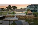 Waterfront home boasts a private dock, tiki hut, and stunning sunset views from the backyard at 4503 Jacona Dr, Hernando Beach, FL 34607