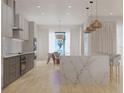 Modern kitchen featuring a large island, barstool seating, and stainless steel appliances at 4535 26Th S Ave, St Petersburg, FL 33711