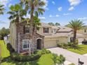 Charming two-story home with a paved driveway and well-manicured lawn at 4544 Vermillion Sky Dr, Wesley Chapel, FL 33544
