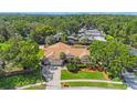 Stunning aerial view of a property with a large home, lush trees, and a private pool area at 512 Crystal Grove Blvd, Lutz, FL 33548