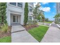 Inviting front entrance with lush green lawn, manicured landscaping and charming architectural details at 5351 Bridge St # 16, Tampa, FL 33611