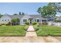 Charming single-story home featuring a meticulously landscaped front yard and welcoming brick walkway at 555 21St Ne Ave, St Petersburg, FL 33704