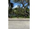 Scenic view of the tranquil river bordered by lush greenery and mature trees at 5608 N River Shore Dr, Tampa, FL 33603
