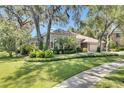 Well-maintained home features manicured lawn, mature landscaping, and beautiful curb appeal at 5804 Terncrest Dr, Lithia, FL 33547