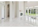 Open-concept living area features fireplace, marble floors, and large windows filling the space with natural light at 6707 Josie Dr, Seffner, FL 33584
