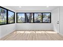 Sun-filled living room boasting new flooring, fresh paint, and updated windows offering great neighborhood views at 711 19Th S Ave, St Petersburg, FL 33705