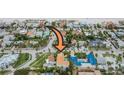 Aerial view shows property location in neighborhood near beach, with pool, and terracotta roof at 831 Mandalay Ave, Clearwater, FL 33767