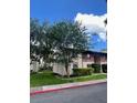 View of the exterior of the apartment with trees on a sunny day at 8636 Tahoe Ct # 13, Tampa, FL 33614