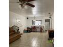 Living room area with tile floors and view into kitchen at 8636 Tahoe Ct # 13, Tampa, FL 33614