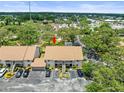 Aerial view of condo complex nestled among lush greenery with ample parking at 9804 Lombard Ct # 104, Tampa, FL 33618