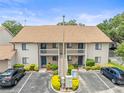 Exterior shot of a charming condo building with balcony and convenient parking at 9804 Lombard Ct # 104, Tampa, FL 33618