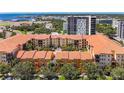 An aerial view of a multi-story building complex with a terracotta-tiled roof and lush green trees at 100 4Th S Ave # 312, St Petersburg, FL 33701