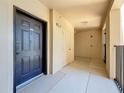 Hallway with door to unit 317, storage closet, and exit sign at 100 4Th S Ave # 312, St Petersburg, FL 33701