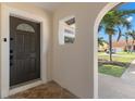 Inviting entryway showcasing an arched doorway and a decorative glass front door at 109 13Th St, Belleair Beach, FL 33786