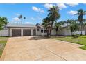Beautiful single-story home featuring a two-car garage and a spacious patterned driveway at 109 13Th St, Belleair Beach, FL 33786