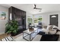 Bright living room with modern fireplace, stylish furniture, and large windows at 109 13Th St, Belleair Beach, FL 33786