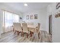 Bright dining room with neutral tones, showcasing a large table, linen chairs and decorative accents at 11336 Callaway Pond Dr, Riverview, FL 33579