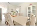 Well-lit dining room features neutral colors, a table set for six, and a contemporary display cabinet at 11336 Callaway Pond Dr, Riverview, FL 33579