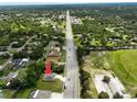 An aerial shot of the property location, close to a baseball field, on a quiet street, and surrounded by trees at 12277 Spring Hill Dr, Spring Hill, FL 34609