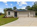 Charming single-Gathering home featuring a three-car garage, solar panels, and a well-manicured lawn at 12277 Spring Hill Dr, Spring Hill, FL 34609