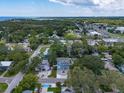 Expansive aerial view captures the neighborhood and house, showing its location in the community at 132 Pennsylvania Ave, Palm Harbor, FL 34683