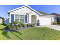 Charming single-Gathering home with well-manicured lawn and two-car garage at 1332 Ocean Spray Dr, Ruskin, FL 33570