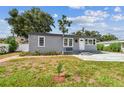 The exterior of this cozy home has a well-kept lawn and tidy landscaping features at 1510 W Powhatan Ave, Tampa, FL 33603