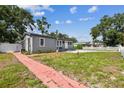 A charming home featuring a pathway and manicured lawn, providing a welcoming entrance at 1510 W Powhatan Ave, Tampa, FL 33603