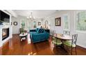 Bright living room with hardwood floors, fireplace, plantation shutters, stylish furnishings, and chandelier at 1731 W Watrous Ave # 202, Tampa, FL 33606