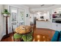 Open living space with hardwood floors features a wooden table and doorway leading into the kitchen at 1731 W Watrous Ave # 202, Tampa, FL 33606