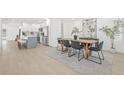Open concept dining room with sleek table set, and new stainless steel kitchen appliances in background at 1901 76Th N Ave, St Petersburg, FL 33702