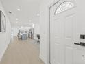 Bright entryway leading to an open-concept kitchen and dining area with modern finishes and light wood floors at 1901 76Th N Ave, St Petersburg, FL 33702