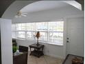 Bright sunroom with tiled flooring, large windows, and comfortable seating is the perfect relaxation spot at 19417 Gulf Blvd # B110, Indian Rocks Beach, FL 33785